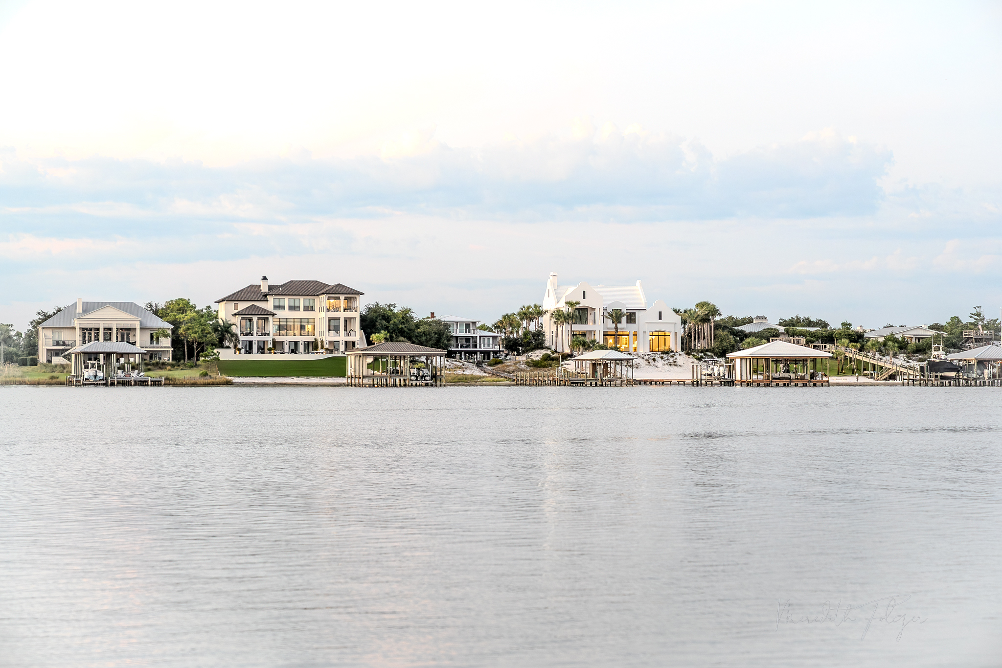 Ono Island ICF Insulated Concrete Form Homes Construction. Waterfront homes on Ole River at sunset in Orange Beach, Alabama, featuring luxury architecture, private boathouses, and Gulf Coast coastal living.